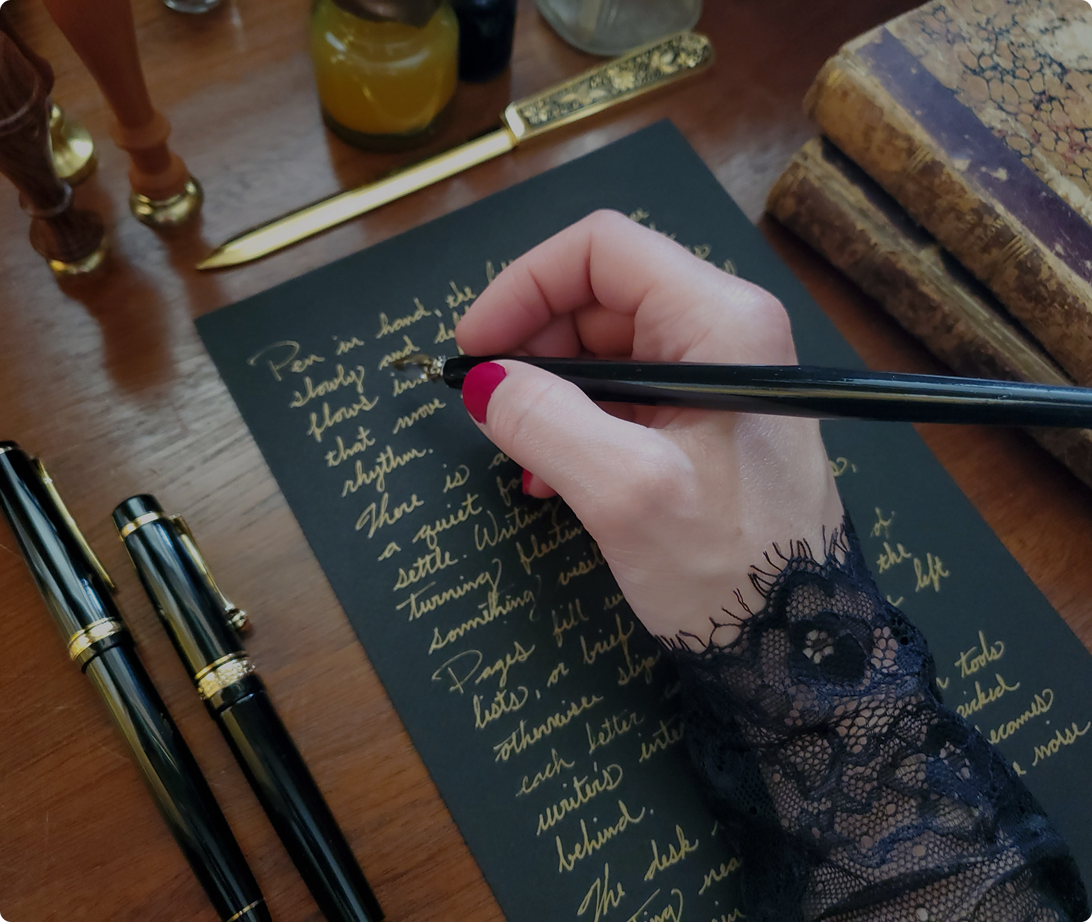 Handwritten intimate letter in cursive gold ink on black paper