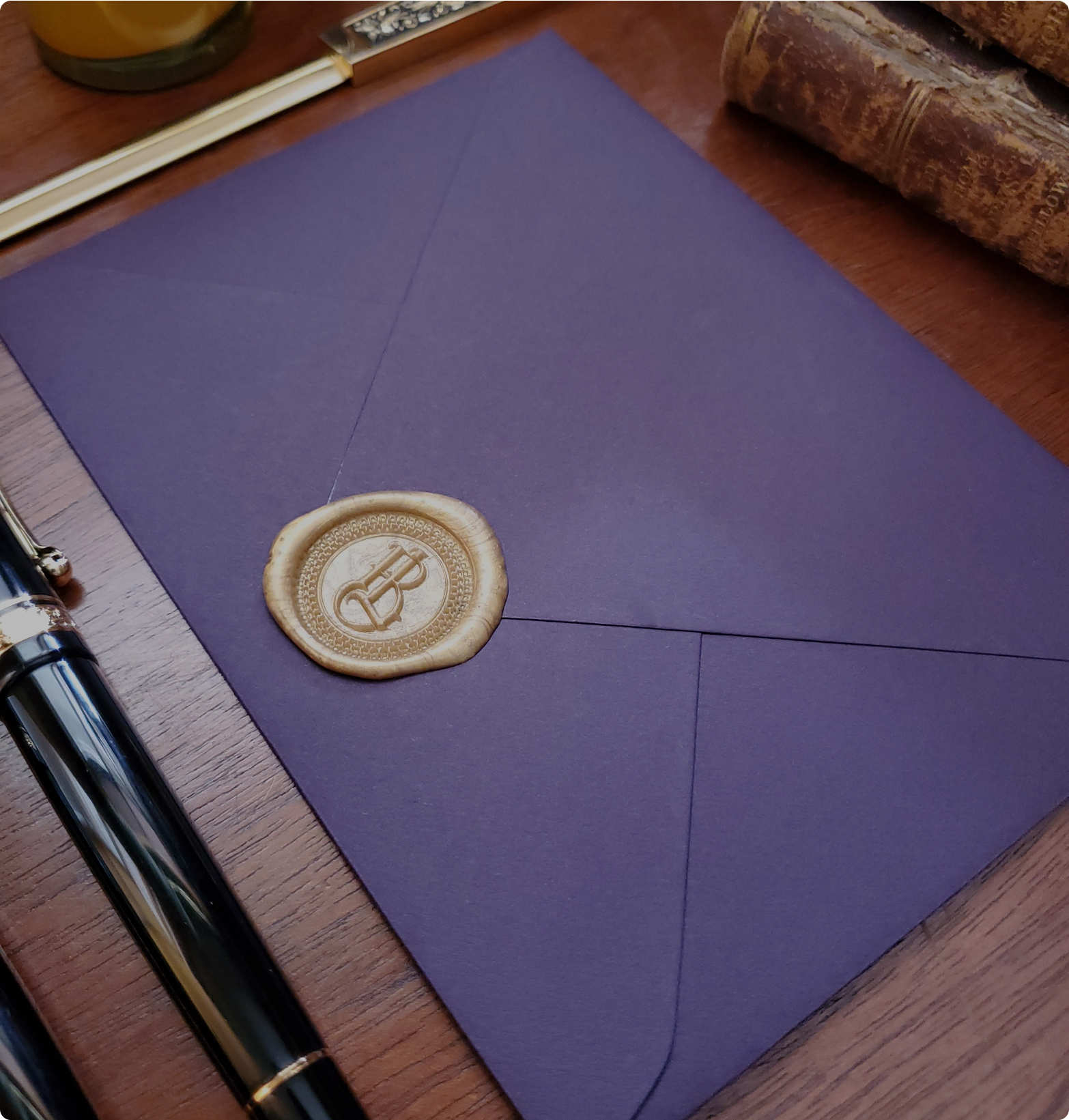 Royal purple envelope with decorative gold wax seal for secret admirer letters
